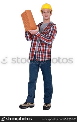 Tradesman holding terracotta shingles