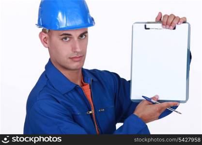 Tradesman holding up a blank clipboard