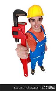Tradesman holding up a pipe wrench
