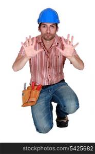 Tradesman holding up his hands