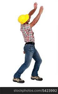 Tradesman lifting an invisible object