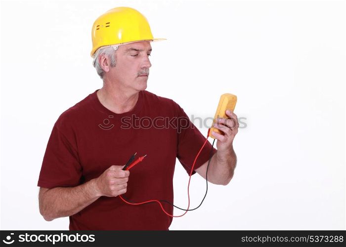 Tradesman looking at his multimeter&rsquo;s display
