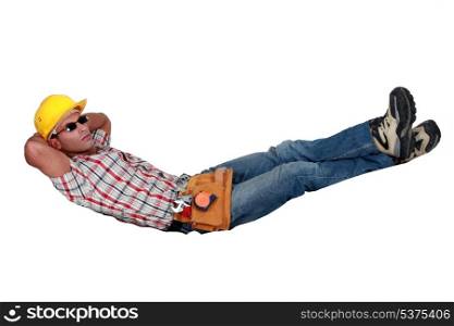 Tradesman lying in an invisible hammock