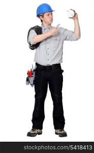 Tradesman pointing to a smoke detector