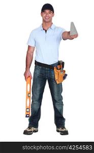 Tradesman posing for the camera with his tools