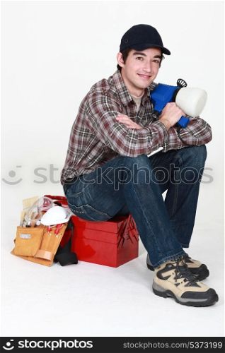 Tradesman posing for the camera with his tools