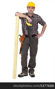 Tradesman posing with his tools and building materials