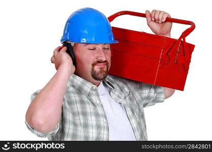 Tradesman pretending to listen to music