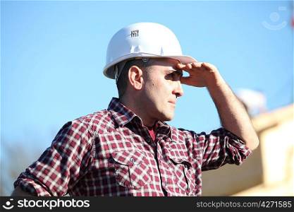 Tradesman shielding his eyes from the sunlight