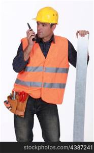 Tradesman speaking into a walkie talkie