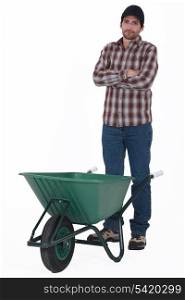 Tradesman standing behind a wheelbarrow