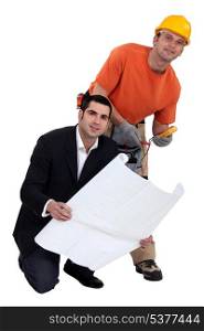 Tradesman standing beside an engineer