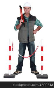 Tradesman standing in front of a barrier