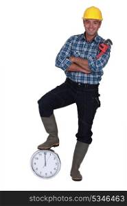 Tradesman stood by a clock