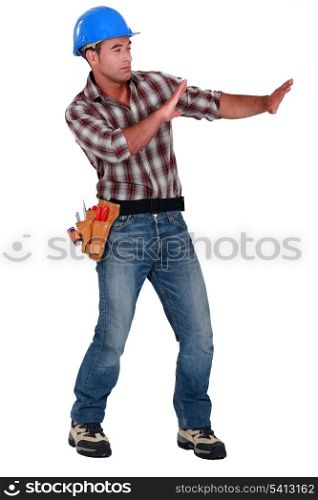 Tradesman trying to protect himself from a shooting object