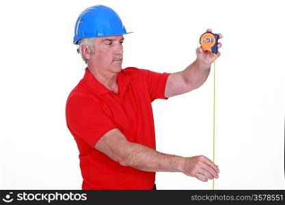 Tradesman using a measuring tape