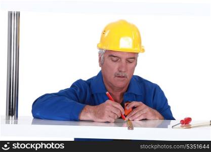 Tradesman using a measuring tape