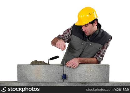 Tradesman using a plumb-bob