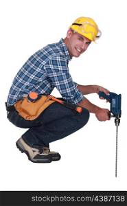 Tradesman using a power tool with a long bit