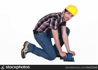 Tradesman using a sander