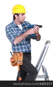 Tradesman using an electric screwdriver