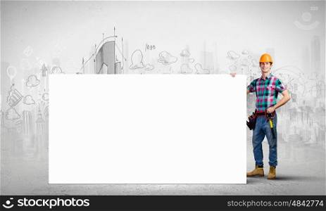 Tradesman with banner. Young repairman holding white blank banner. Place for text