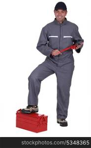 Tradesman with his foot propped on a toolbox