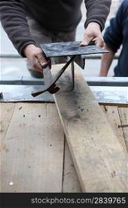 Tradesman working with metal and wood