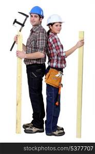 Tradespeople holding tools and materials