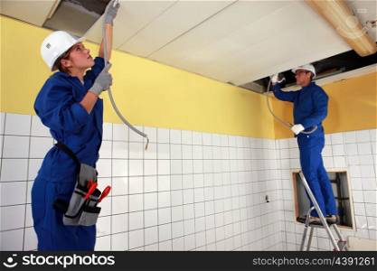 Tradespeople installing a heating system