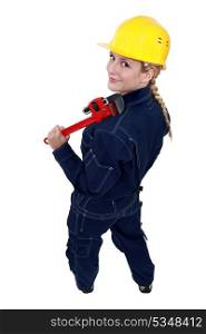 Tradeswoman holding a pipe wrench
