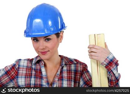 Tradeswoman holding a plank of wood