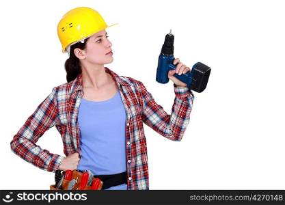 Tradeswoman holding an electric screwdriver