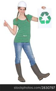 Tradeswoman holding the recycling symbol