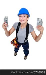 Tradeswoman holding up wads of cash
