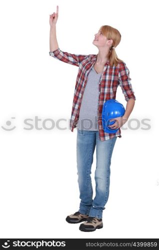 Tradeswoman pointing to the ceiling