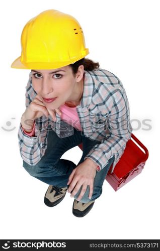 Tradeswoman sitting on toolbox
