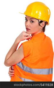 Tradeswoman wearing a hart hat and an orange vest