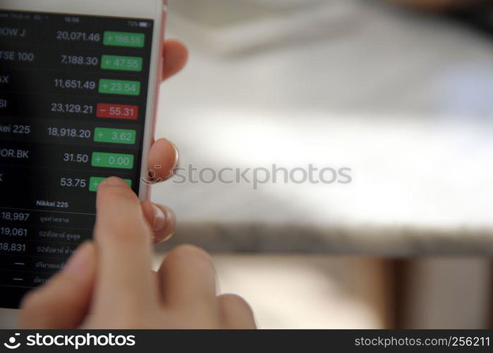 trading online on smartphone with bussiness woman hand