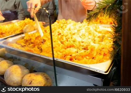 Tradiotional german fried potto at Christmas market kiosk. Tradiotional german fried potato