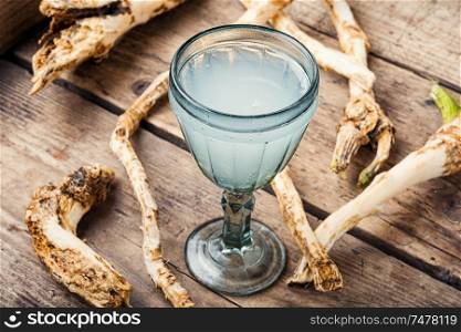 Traditional alcoholic drink from horseradish roots.Russian or Ukrainian cuisine. Alcoholic drink on horseradish