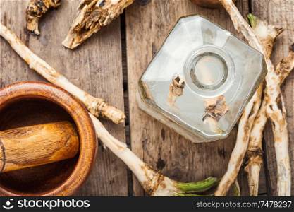 Traditional alcoholic drink from horseradish roots.Russian or Ukrainian cuisine. Alcoholic drink on horseradish