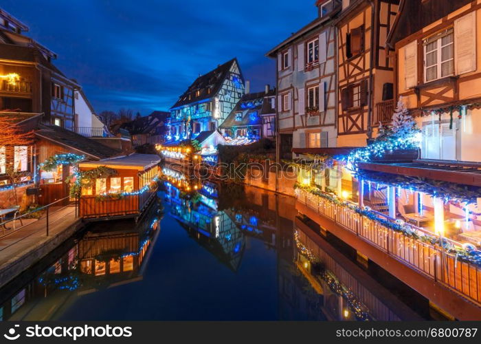 Traditional Alsatian half-timbered houses and river Lauch in Petite Venise or little Venice, old town of Colmar, decorated and illuminated at christmas time, Alsace, France