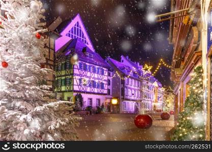 Traditional Alsatian half-timbered houses in old town of Colmar, decorated and illuminated at christmas time, Alsace, France. Christmas street at night in Colmar, Alsace, France