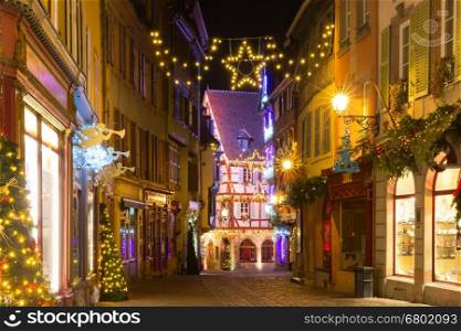 Traditional Alsatian half-timbered houses in old town of Colmar, decorated and illuminated at christmas time, Alsace, France
