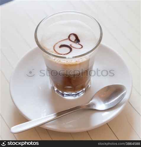 Traditional and artistic Italian coffee with milk and decoration