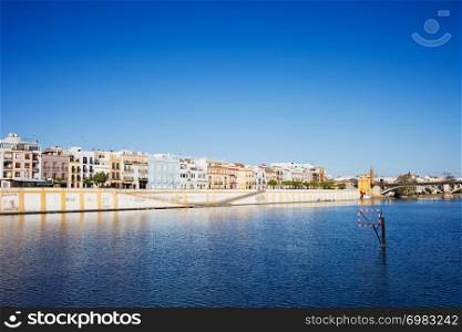 Traditional apartment houses on the west bank of the Guadalquivir River in the city of Seville, Andalusia, Spain.