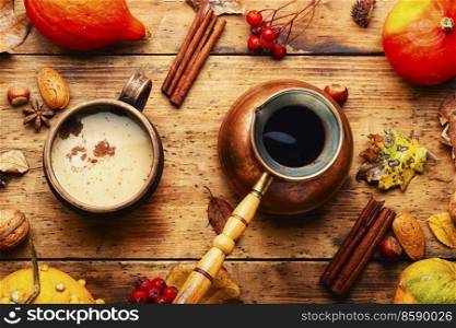 Traditional autumn coffee drink, pumpkin latte on rustic wooden surface. Tasty pumpkin latte,coffee