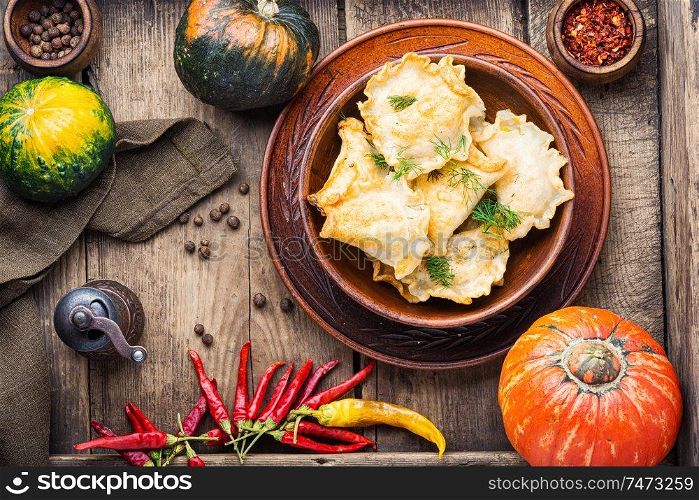 Traditional autumnal pumpkin dumplings.Fried pumpkin vareniki.Autumn food. Homemade varenyky with pumpkin