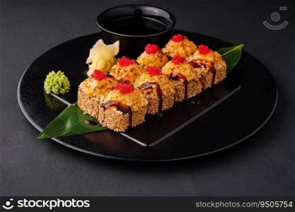 Traditional baked japanese sushi on black plate